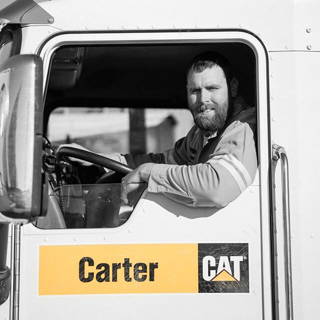 A Carter Cat employee driving a Carter Cat truck